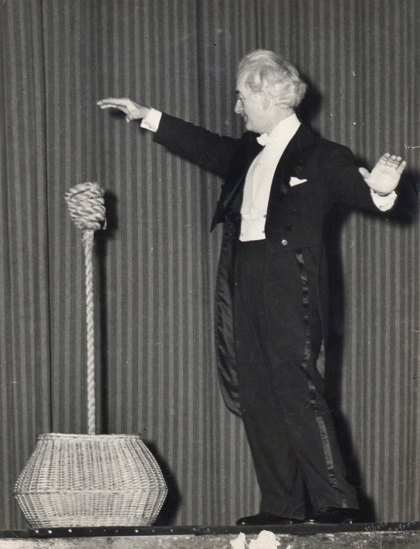 Harry Blackstone Sr. performing the Indian rope trick on stage.